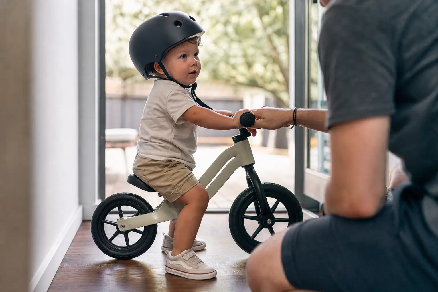 Toddler seated on balance bike, feet flat