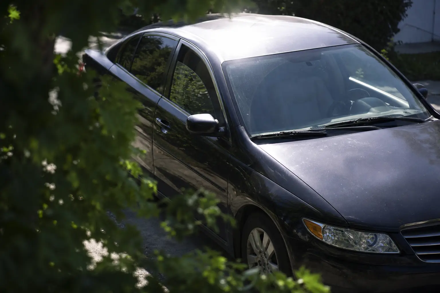 Parked car with cracked window in direct sun